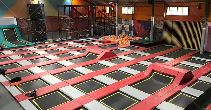 Commercial trampoline arena layout with multiple jumping zones and foam pit for youth recreation and group activities